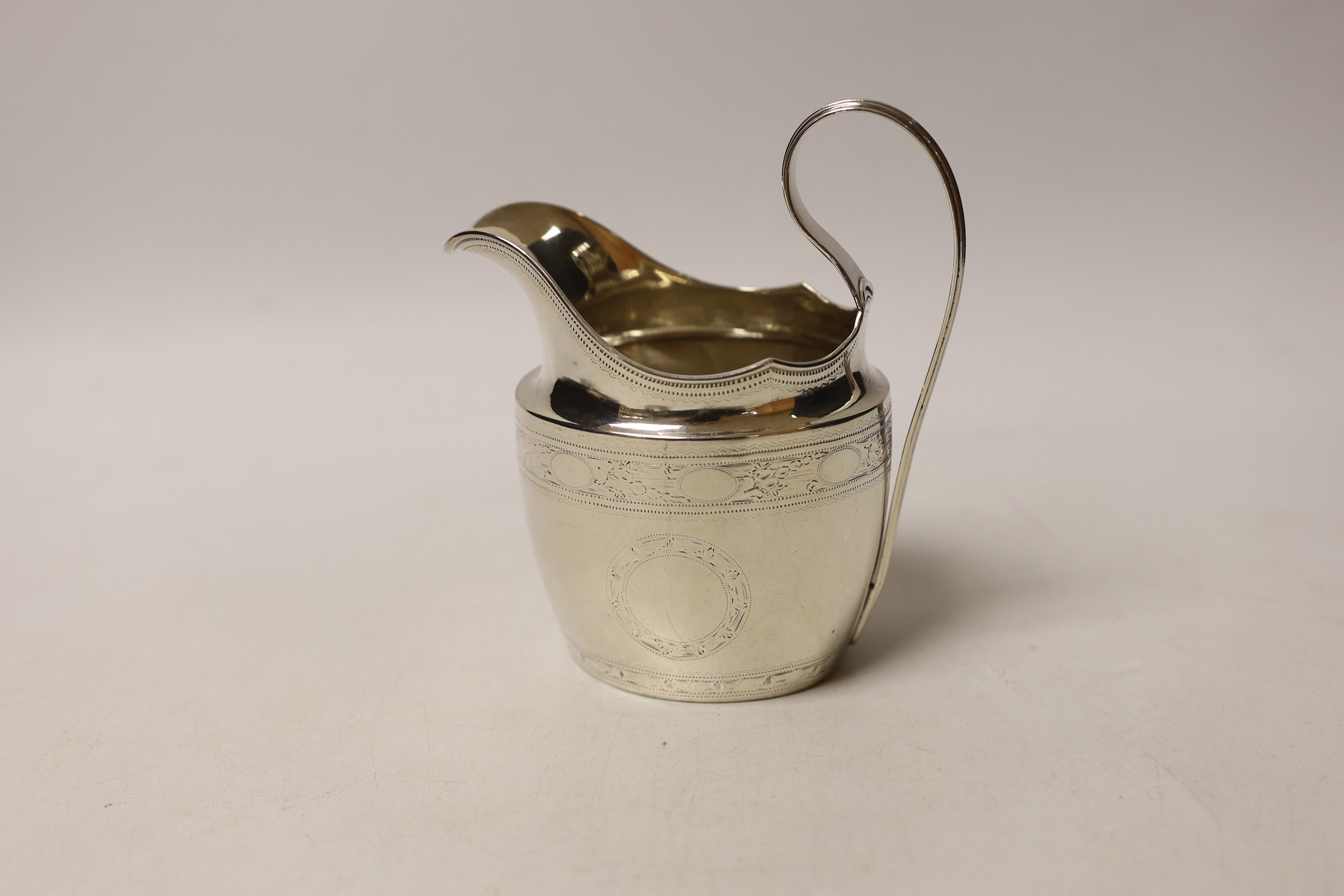 An early 19th century Irish engraved silver cream jug, crowned harp mark only, 13cm, 4.5oz.